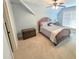 Bedroom features carpet floors, ceiling fan, and a decorative trunk at 7483 Danford Rd, Burlington, NC 27215