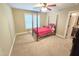 This sun-filled bedroom provides a relaxing space with carpet floors and a four-poster bed at 7483 Danford Rd, Burlington, NC 27215