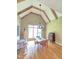 Formal dining room features a glass table, chandelier, hardwood floors, and decorative wood beams at 7483 Danford Rd, Burlington, NC 27215