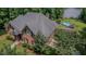 Brick home featuring a pool, trampoline, and access to the lake, as well as mature trees in a park-like setting at 7483 Danford Rd, Burlington, NC 27215