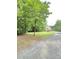 Beautiful single Gathering home surrounded by green grass and lush trees at 7483 Danford Rd, Burlington, NC 27215