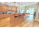 Spacious kitchen with a central island, stainless steel appliances, and hardwood flooring at 7483 Danford Rd, Burlington, NC 27215