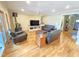 Cozy living room with hardwood floors, comfortable seating, and a wood-burning stove at 7483 Danford Rd, Burlington, NC 27215