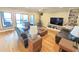 Spacious living room with leather seating, wood-burning stove, and a sliding door to the porch at 7483 Danford Rd, Burlington, NC 27215