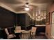 Cozy screened porch with dining set, fan, and ambient lighting, perfect for relaxing or entertaining at 7483 Danford Rd, Burlington, NC 27215