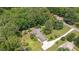A high angle aerial view shows the home, trees and long driveway at 8133 Holly Forest Rd, Wake Forest, NC 27587