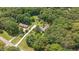 Aerial view of the house on a large wooded lot with many mature trees at 8133 Holly Forest Rd, Wake Forest, NC 27587