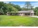 Expansive backyard featuring a covered patio and green grass at 8133 Holly Forest Rd, Wake Forest, NC 27587
