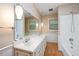 Bathroom featuring a double vanity, large mirror, shower, and tub at 8133 Holly Forest Rd, Wake Forest, NC 27587