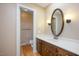 Bathroom featuring vanity with sink, mirror, and adjacent toilet at 8133 Holly Forest Rd, Wake Forest, NC 27587