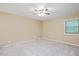 Spacious bedroom featuring neutral carpet, ceiling fan, and double hung windows at 8133 Holly Forest Rd, Wake Forest, NC 27587