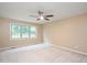 Bright bedroom with neutral carpet, a ceiling fan, and a large window overlooking the yard at 8133 Holly Forest Rd, Wake Forest, NC 27587