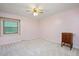 Bedroom with carpet, double hung windows, ceiling fan, and a decorative cabinet at 8133 Holly Forest Rd, Wake Forest, NC 27587