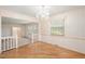 Open-concept dining room with hardwood floors and stylish chandelier at 8133 Holly Forest Rd, Wake Forest, NC 27587