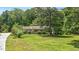 Inviting home exterior with a well-kept lawn, garden and mature landscaping at 8133 Holly Forest Rd, Wake Forest, NC 27587
