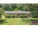 Charming home exterior with stone accents, manicured bushes and a lush green lawn at 8133 Holly Forest Rd, Wake Forest, NC 27587