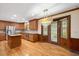 Traditional kitchen with wood cabinets, stainless steel appliances, island, and access to the backyard at 8133 Holly Forest Rd, Wake Forest, NC 27587