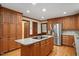 Modern kitchen with stainless steel refrigerator and island cooktop at 8133 Holly Forest Rd, Wake Forest, NC 27587