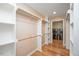 Walk-in laundry room and closet with white shelving and a set of modern washer and dryer at 8133 Holly Forest Rd, Wake Forest, NC 27587