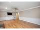 The living room has a ceiling fan, hardwood flooring, and wainscoting on the bottom half of the walls at 8133 Holly Forest Rd, Wake Forest, NC 27587