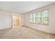 Spacious living room featuring large windows and neutral carpeting at 8133 Holly Forest Rd, Wake Forest, NC 27587