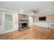 Spacious living room featuring hardwood floors, a stone fireplace, and recessed lighting at 8133 Holly Forest Rd, Wake Forest, NC 27587