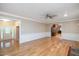 Open living area with hardwood floors leading to the entryway and kitchen at 8133 Holly Forest Rd, Wake Forest, NC 27587