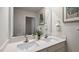 Bright bathroom featuring double vanity with white countertop and large mirror at 818 Comice Pear Way, Willow Springs, NC 27592