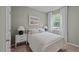 Cozy bedroom featuring a white metal frame bed, soft lighting, and a large window with natural light at 818 Comice Pear Way, Willow Springs, NC 27592