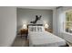 Cozy bedroom with neutral colors, accent wall decor, and a window with natural light at 818 Comice Pear Way, Willow Springs, NC 27592