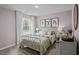 Comfortable bedroom with a metal frame bed, soft bedding, and warm lighting, creating a peaceful retreat at 818 Comice Pear Way, Willow Springs, NC 27592