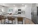 Modern kitchen featuring an island with barstool seating, granite countertops and stainless steel appliances at 818 Comice Pear Way, Willow Springs, NC 27592