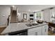 Open concept kitchen with a view of the living room, granite countertops, and modern appliances at 818 Comice Pear Way, Willow Springs, NC 27592