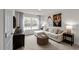 Comfortable living room with a sectional sofa, large window, and stylish decor, perfect for relaxation at 818 Comice Pear Way, Willow Springs, NC 27592