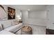 Inviting living room featuring a cozy sectional sofa, unique ottoman, and stylish artwork, creating a relaxing atmosphere at 818 Comice Pear Way, Willow Springs, NC 27592