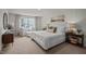 Serene main bedroom with a large window, comfortable seating area, and a plush, inviting bed at 818 Comice Pear Way, Willow Springs, NC 27592