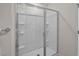 Modern bathroom featuring a glass-enclosed shower with built-in shelving and sleek fixtures at 818 Comice Pear Way, Willow Springs, NC 27592