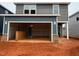 View of garage with gray siding at 829 Ottawa Dr, Garner, NC 27529