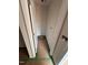 Narrow hallway featuring fresh white paint, with a door, a view to flooring and electrical box at 829 Ottawa Dr, Garner, NC 27529