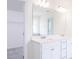 Bright bathroom features a double vanity with white cabinets, modern fixtures, and an expansive mirror at 925 Kinglet House Rd, Knightdale, NC 27545