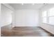 Empty room with hardwood floors, plenty of natural light, and fresh white paint at 925 Kinglet House Rd, Knightdale, NC 27545