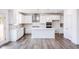 Modern kitchen featuring stainless appliances, white cabinets, large island, and pendant lighting at 925 Kinglet House Rd, Knightdale, NC 27545