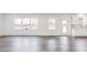 Inviting living room with wood floors, large windows, and plenty of natural light at 925 Kinglet House Rd, Knightdale, NC 27545