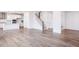 Spacious living room with wood floors, staircase, and open kitchen layout at 925 Kinglet House Rd, Knightdale, NC 27545