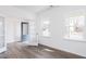 Open-concept living room with beautiful windows and new wood-look flooring at 925 Kinglet House Rd, Knightdale, NC 27545