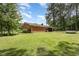 Expansive backyard with lush green grass surrounds the brick home at 9751 N Highway 96, Selma, NC 27576