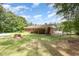 Picturesque backyard featuring a well-kept lawn and partially covered porch at 9751 N Highway 96, Selma, NC 27576