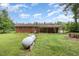 A spacious green lawn, propane tank, and covered porch enhance this backyard at 9751 N Highway 96, Selma, NC 27576