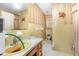 Classic bathroom with yellow tile, floral wallpaper, and traditional fixtures at 9751 N Highway 96, Selma, NC 27576