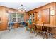 Charming dining area with a wooden table, vintage chandelier, and wood-paneled walls at 9751 N Highway 96, Selma, NC 27576